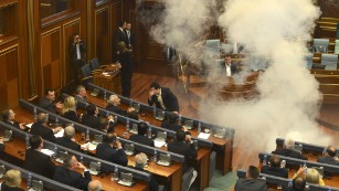 Image #: 39960874    epa04968521 Opposition lawmakers throw tear gas during a session of Kosovo's parliament in Pristina, Kosovo 08 October 2015. Kosovo's opposition political parties protest against the agreements that has been reached during the EU-brokered dialogue with Serbia.  EPA/PETRIT PRENAJ /LANDOV