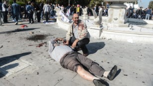 A wounded man lays on the ground at the site of an explosion in Ankara, Turkey, on Saturday, October 10. Two powerful bombs exploded near the main train station in Ankara on Saturday morning