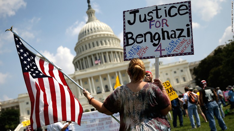 WASHINGTON, DC - SEPTEMBER 11:  Jennifer Brandt holds signs during a "Call to Action" rally held by various conservative organizations on the grounds of the U.S. Capitol, marking the one year anniversary of the attacks on the U.S. compound in Benghazi September 11, 2013 in Washington, DC. U.S. Ambassador Chris Stevens, Sean Smith, Glen Doherty and Tyrone Woods were all killed during the attacks last year. 