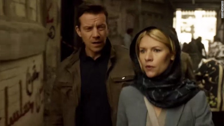 Claire Danes star of hit U.S. TV series &quot;Homeland&quot; walks past graffiti on a wall that says in Arabic: &quot;Homeland is NOT a series.&quot; 