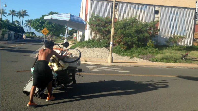 A homeless man pushes his belongings in Honolulu.