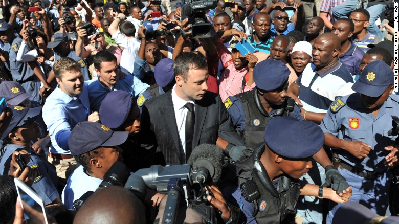 Oscar Pistorius, wearing the black tie, arrives outside a courtroom in Pretoria, South Africa, on October 21, 2014.