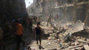 Syrians check the rubble following an airstrike in Aleppo last month.