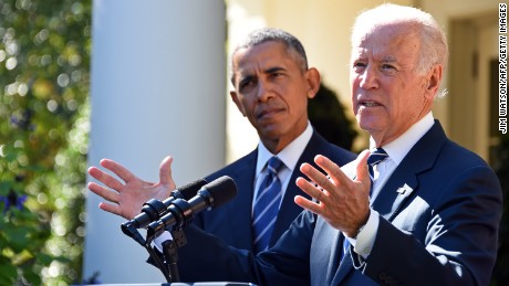 US Vice President Joe Biden (R), flanked by US President Barack Obama (L), speaks in the Rose Garden at the White House on October 21, 2015, in Washington, DC. Biden announced that he is not running for president. AFP PHOTO / JIM WATSON        (Photo credit should read JIM WATSON/AFP/Getty Images)