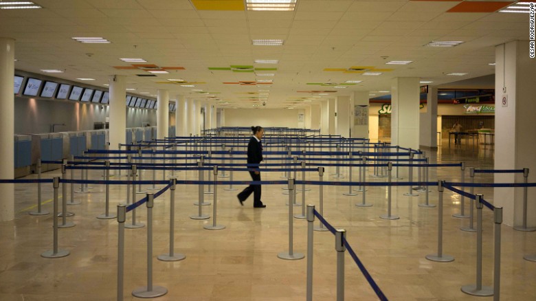 An airline employee walks around the empty airport in Puerto Vallarta, where all flights were canceled on October 23.