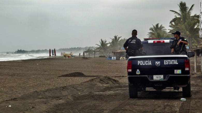 Police patrol the beach in Boca de Pascuales on October 22.