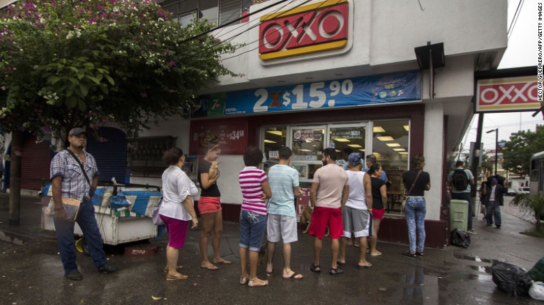 People line up to buy food and water in Puerto Vallarta on October 23.