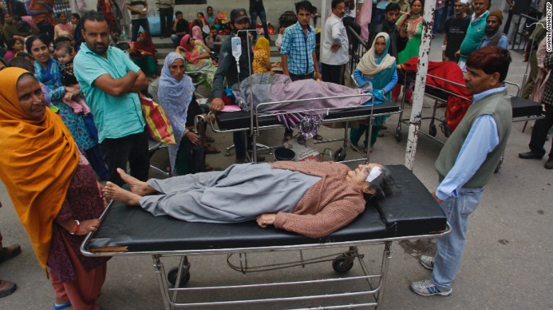 Patients who were shifted outdoors at the government medical college hospital after a strong tremor was felt in Jammu, India, Monday, Oct. 26, 2015. A strong earthquake in northern Afghanistan was felt across much of South Asia on Monday, shaking buildings from Kabul to Delhi and cutting power and communications in some areas. (AP Photo/Channi Anand)