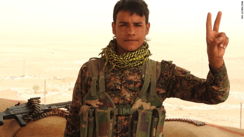 A Kurdish YPG fighter poses for a photograph on the frontline in northern Syria