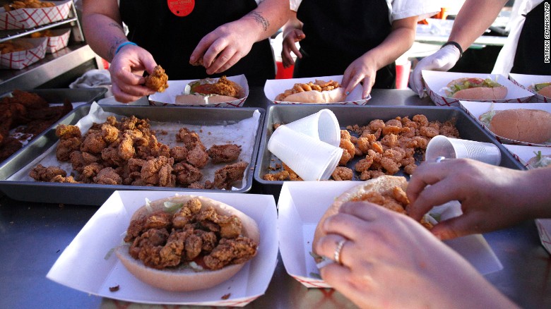 The po&#39; boy sandwich originated in New Orleans and is typically served on French bread, although there are many varieties. Here workers make oyster and shrimp po&#39; boy sandwiches in the Vucinovich&#39;s Restaurant food booth at the New Orleans Jazz and Heritage Festival.