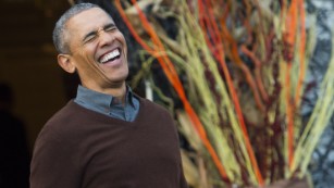 U.S. President Barack Obama laughs as he arrives to hand out treats to children trick-or-treating for Halloween on the South Lawn of the White House in Washington, D.C., October 30, 2015.