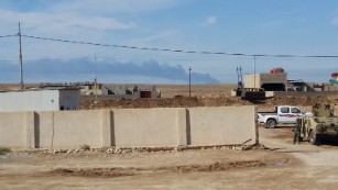 A smoke plume rises as coalition planes bomb an ISIS position