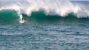 A surfer rides a wave at Waimea Bay October 28.