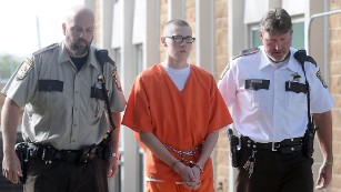 John LaDue is escorted to the Waseca County Courthouse for his sentencing hearing Monday, Oct. 19, 2015, in Waseca, Minn. LaDue, who was charged more than a year and a half ago in a plot to bomb his Waseca school, was sentenced Monday to up to 10 years of probation and treatment at a secured autism spectrum disorder facility in Georgia. (Pat Christman/Mankato Free Press via AP)