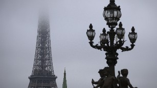 A view of the Eiffel Tower seen through smog on October 29, 2015 in Paris.  AFP PHOTO / JOEL SAGET        (Photo credit should read JOEL SAGET/AFP/Getty Images)