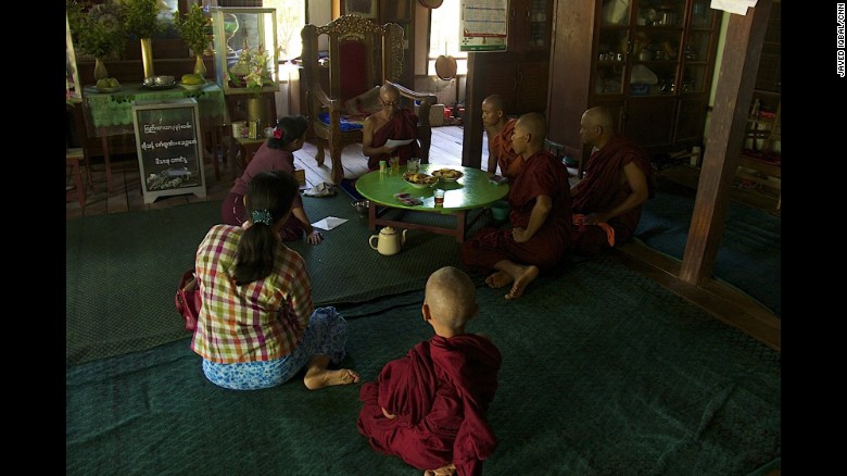 People sit at the Buddhist monastery Meiktila Burma, where U Wie Douktah gave shelter to Muslims in 2013.