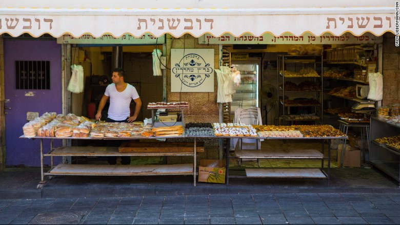 Idan Sharabi waits for customers at his pastry shop in Jerusalem&#39;s Mahane Yehuda market. 