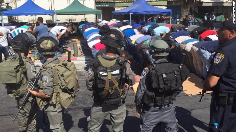 Israeli security forces surround Muslim worshipers during Friday prayers outside the Old City of Jerusalem. 