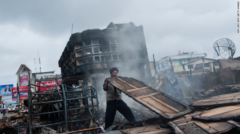 A fireman begins to clean up a burnt down market after riots broke out in Lashio in eastern Myanmar's Shan state on May 30, 2013. Security forces patrolled the riot-scarred streets of the town in eastern Myanmar after a fresh outbreak of religious violence that left one dead and several wounded. One person was killed and five injured in fighting between Muslims and Buddhists that saw a mosque and orphanage torched and stick-wielding mobs roaming the streets threatening Muslims.