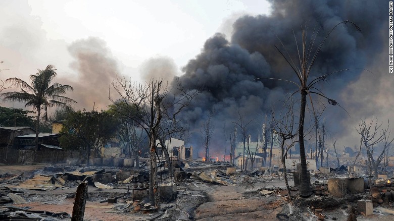 Black smoke rises from burning houses around a mosque in riot-hit Meiktila, central Myanmar on March 21, 2013.