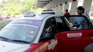 A woman takes a special female only taxi 