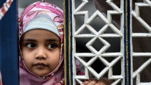 A Malaysian Muslim child watches Eid al-Adha celebrations at the Sultan Salahuddin Abdul Aziz mosque in Shah Alam on September 24, 2015. 