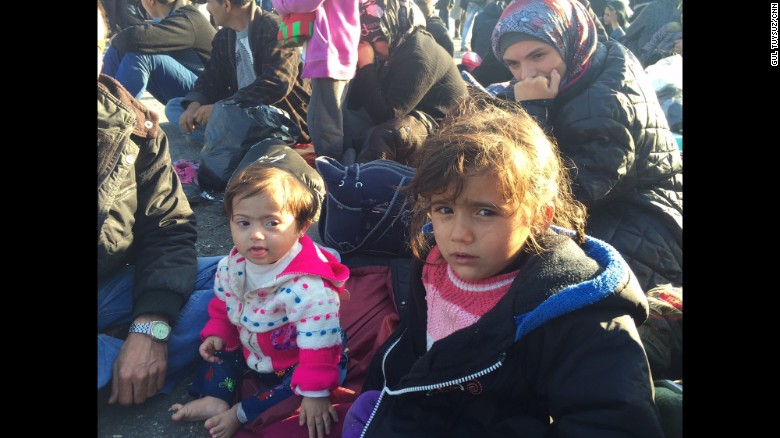 Emine and Wahibe, aged 2.5 and 4, respectively, are sisters from Aleppo, Syria. They are waiting with their parents for the boat to take them to Athens.