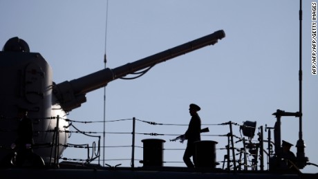 A Russian Navy member stands guard on the deck of the Pyotr Velikiy (Peter the Great) Russian nuclear-powered missile cruiser docked in the Cypriot port of Limassol, on February 12, 2014. The Russian ship is part of the team involved in escorting shipments of Syria's chemical weapons material for destruction. AFP PHOTO / YIANNIS KOURTOGLOU        (Photo credit should read Yiannis Kourtoglou/AFP/Getty Images)