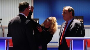 Image #: 40744570    Republican U.S. presidential candidate and former U.S. Senator Rick Santorum (L) gets a touchup from a network makeup artist (C) as New Jersey Governor Chris Christie (R) looks on during a commercial break in the midst of a forum for lower polling candidates held by Fox Business Network before the 2016 U.S. Republican presidential candidates debate in Milwaukee, Wisconsin, November 10, 2015. REUTERS/Jim Young /LANDOV