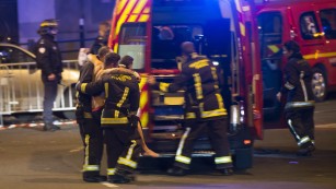 Wounded people are evacuated from the Stade de France in Paris on November 13 after explosions were reported during a football match between France and Germany.