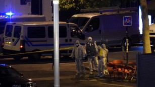 Forensic experts inspect the site of an attack, a restaurant outside the Stade de France stadium in Saint-Denis, north of Paris, early on November 14, 2015, after a series of gun attacks occurred across Paris as well as explosions outside the national stadium where France was hosting Germany. 