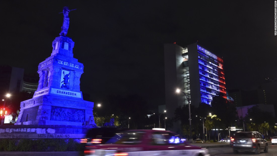 The Senate building in Mexico City is lit up blue, white and red.