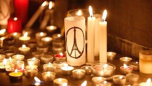 Candles are lit as people gather in Hong Kong, Saturday, Nov. 14, 2015, to mourn for the victims killed in Friday's attacks in Paris. French President Francois Hollande said more than 120 people died Friday night in shootings at Paris cafes, suicide bombings near France's national stadium and a hostage-taking slaughter inside a concert hall.  (AP Photo/Kin Cheung)