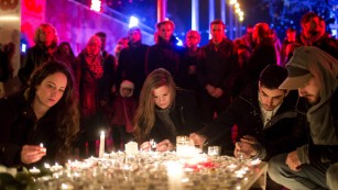 People light candles in tribute to the Paris victims on Sunday, November 15 in Budapest, Hungary.