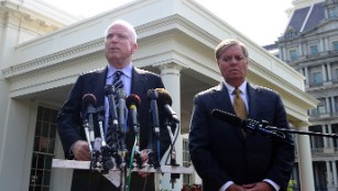 US Senator John McCain, R-AZ, answers a question as Senator Lindsey Graham, R-SC, looks on following their meeting with US President Barack Obama at the White House in Washington, DC, on September 2, 2013. McCain said Monday that Congress's failure to authorize military action in Syria would be "catastrophic" because it would undermine US credibility.AFP Photo/Jewel Samad        (Photo credit should read JEWEL SAMAD/AFP/Getty Images)