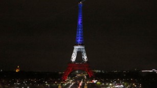 The Eiffel Tower is illuminated in the French national colors red, white and blue in honor of the victims of the terror attacks last Friday in Paris, Monday, Nov. 16, 2015.  France is urging its European partners to move swiftly to boost intelligence sharing, fight arms trafficking and terror financing, and strengthen border security in the wake of the Paris attacks. (AP Photo/Frank AugsteinAP)