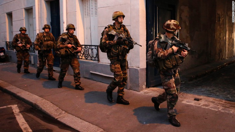 Soldiers operate in St. Denis, a northern suburb of Paris, Wednesday, Nov. 18, 2015. Authorities in the Paris suburb of St. Denis are telling residents to stay inside during a large police operation near France's national stadium that two officials say is linked to last week's deadly attacks. (AP Photo/Francois Mori)