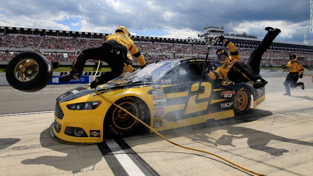NASCAR driver Brad Keselowski accidentally crashes into two of his crew members during a Sprint Cup race Sunday, August 2, at Pennsylvania&#39;s Pocono Raceway. Neither crew member was hurt.