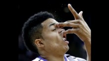 Kansas State's Justin Edwards catches an opponent's hand to the face while playing in a Big 12 tournament game Wednesday, March 11, in Kansas City, Missouri.