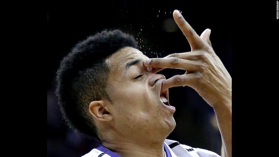 Kansas State&#39;s Justin Edwards catches an opponent&#39;s hand to the face while playing in a Big 12 tournament game Wednesday, March 11, in Kansas City, Missouri.