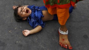 Image #: 40900687    A Hindu woman steps over a child in a ritual seeking blessings for the child from the Sun god Surya during the Hindu religious festival of Chatt Puja in Kolkata, India, November 17, 2015. Hindu women fast for the whole day for the betterment of their family and the society during the festival. REUTERS/Rupak De Chowdhuri      TPX IMAGES OF THE DAY      /LANDOV