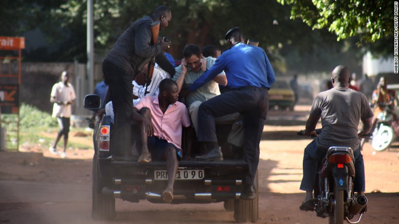 Security forces escort hostages who were freed from the Radisson Blu Hotel in Bamako, Mali, on Friday, November 20. Gunmen stormed the hotel and took 170 hostages. At least 21 deaths have been reported. No group immediately claimed responsibility for the attack.