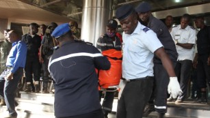 Officers evacuate bodies of victims from the Radisson Blu hotel in Bamako on November 20, 2015, after the assault of security forces. Malian forces backed by French troops stormed the Radisson Blu hotel in the capital Bamako after suspected Islamist gunmen seized guests and staff in a nine-hour hostage crisis that left at least 18 people dead. UN Secretary-General Ban Ki-moon condemned the "horrific terrorist attack" on November 20, and indicated the violence was aimed at destroying peace efforts in the country. AFP PHOTO / HABIBOU KOUYATE        (Photo credit should read HABIBOU KOUYATE/AFP/Getty Images)