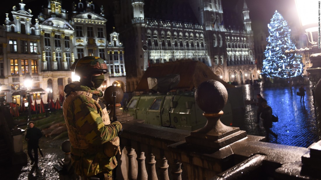A Belgian soldier stands guard around a security perimeter as a reported police intervention takes place around the Grand Place central square in Brussels on Sunday, November 22.  Multiple raids took place throughout Brussels, according to the Belgium Federal prosecutor, and 16 people were arrested. Salah Abdeslam, a suspect in Paris terror attacks, was not among them. 