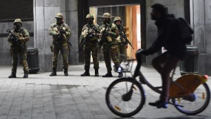 Soldiers stand guard in front of the Brussels Central Train Station on Sunday as the Belgian capital remained on the highest security alert level over fears of a Paris-style attack.     