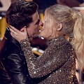 LOS ANGELES, CA - NOVEMBER 22:  Singers Charlie Puth (L) and Meghan Trainor kiss onstage during the 2015 American Music Awards at Microsoft Theater on November 22, 2015 in Los Angeles, California.  (Photo by Kevin Winter/Getty Images)