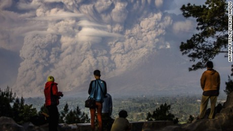 Image #: 34813621    People watch as Mt. Sinabung ejects ash into the air during an eruption in Karo regency, Indonesia's North Sumatra province February 9, 2015  in this photo taken by Antara Foto.   Mandatory Credit. REUTERS/Antara Foto/Endro Lewa  (INDONESIA - Tags: ENVIRONMENT DISASTER TPX IMAGES OF THE DAY)    MANDATORY CREDIT:  REUTERS /ANTARA FOTO /LANDOV