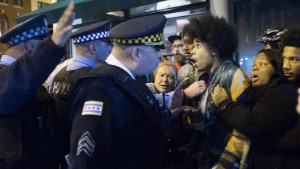 CHICAGO, IL - NOVEMBER 25:  Demonstrators confront police during a protest over the death of Laquan McDonald on November 25, 2015 in Chicago, Illinois. Small and mostly peaceful protests have sprouted up around the city following yesterday's release of a video showing Chicago Police officer Jason Van Dyke shooting and killing 17-year-old McDonald. Van Dyke has been charged with first degree murder for the October 20, 2014 shooting in which McDonald was hit with 16 bullets.  (Photo by Scott Olson/Getty Images)