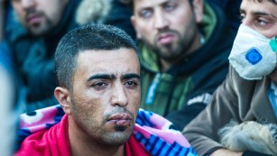 A man with his mouth sewn shut silently protests on the Greek-Macedonian border.