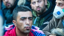 A man with his mouth sewn shut silently protests on the Greek-Macedonian border.